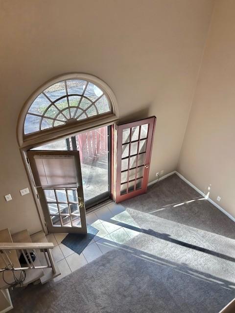 entryway with carpet floors and tile patterned flooring