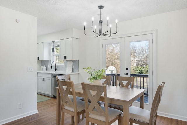 dining space featuring dark wood-style floors, baseboards, and a textured ceiling