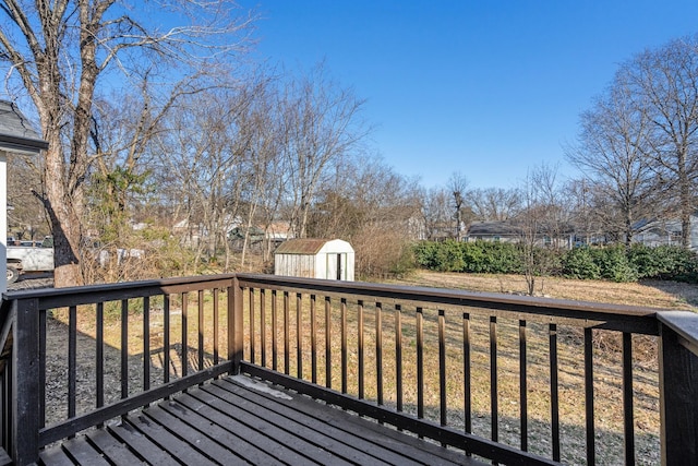 deck featuring a storage unit, a lawn, and an outdoor structure