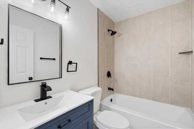 full bath featuring  shower combination, vanity, toilet, and a textured ceiling