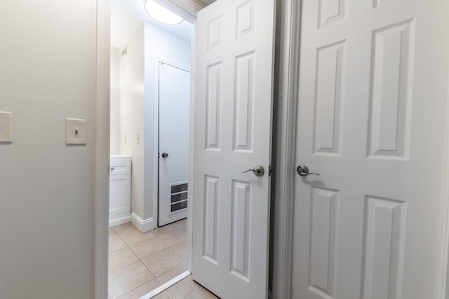 corridor featuring light tile patterned floors