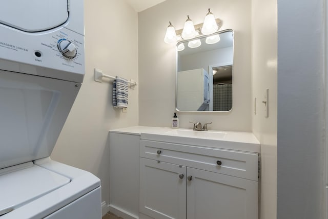 bathroom with stacked washer / dryer and vanity