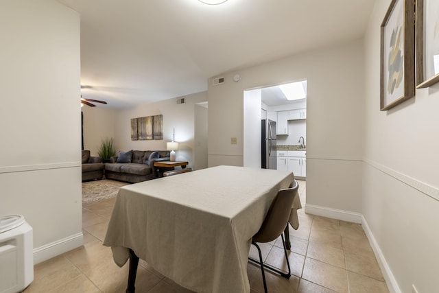 dining area featuring visible vents, ceiling fan, baseboards, and light tile patterned floors