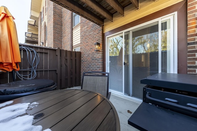 wooden terrace with fence and a hot tub