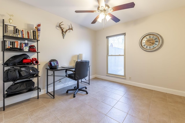 office area with light tile patterned floors, a ceiling fan, and baseboards