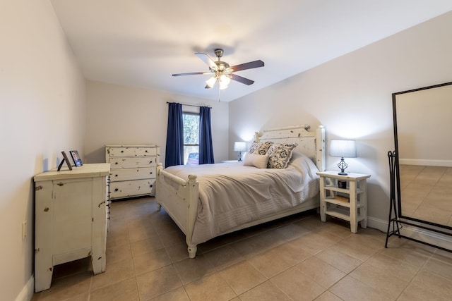 bedroom with ceiling fan, baseboards, and light tile patterned floors