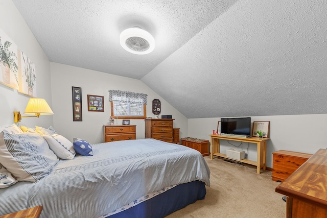 bedroom with lofted ceiling, a textured ceiling, and light colored carpet