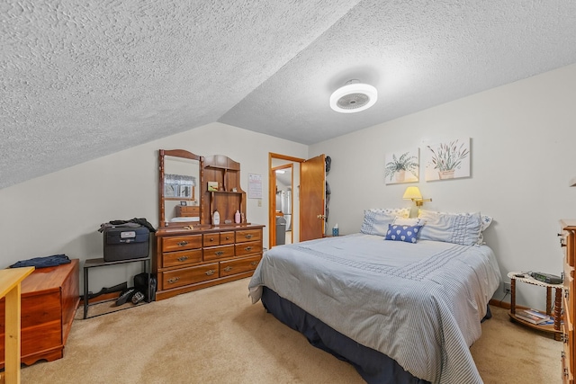 carpeted bedroom with vaulted ceiling and a textured ceiling