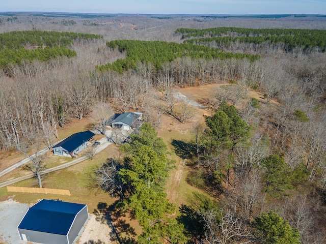 bird's eye view with a wooded view