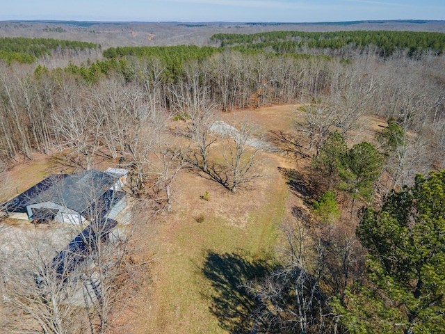 bird's eye view with a wooded view