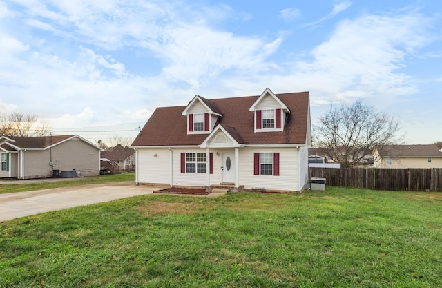 cape cod-style house with concrete driveway, a front yard, and fence