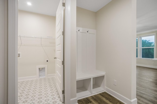 mudroom featuring dark floors and baseboards