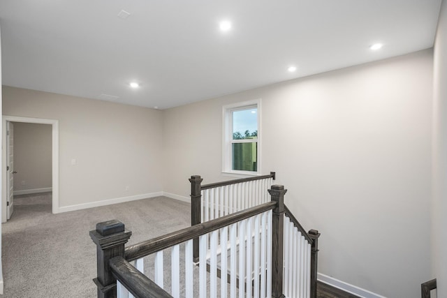 hallway with recessed lighting, carpet flooring, an upstairs landing, and baseboards