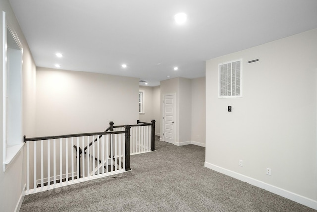 empty room with recessed lighting, baseboards, visible vents, and carpet flooring