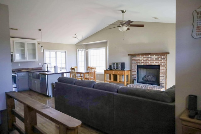 1335 Bumpus Mills Rd, Dover, TN 37058 - living area featuring visible vents, ceiling fan with notable chandelier, a brick fireplace, and lofted ceiling