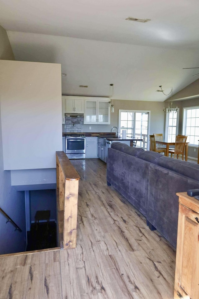1335 Bumpus Mills Rd, Dover, TN 37058 - living area with visible vents, lofted ceiling, and wood finished floors