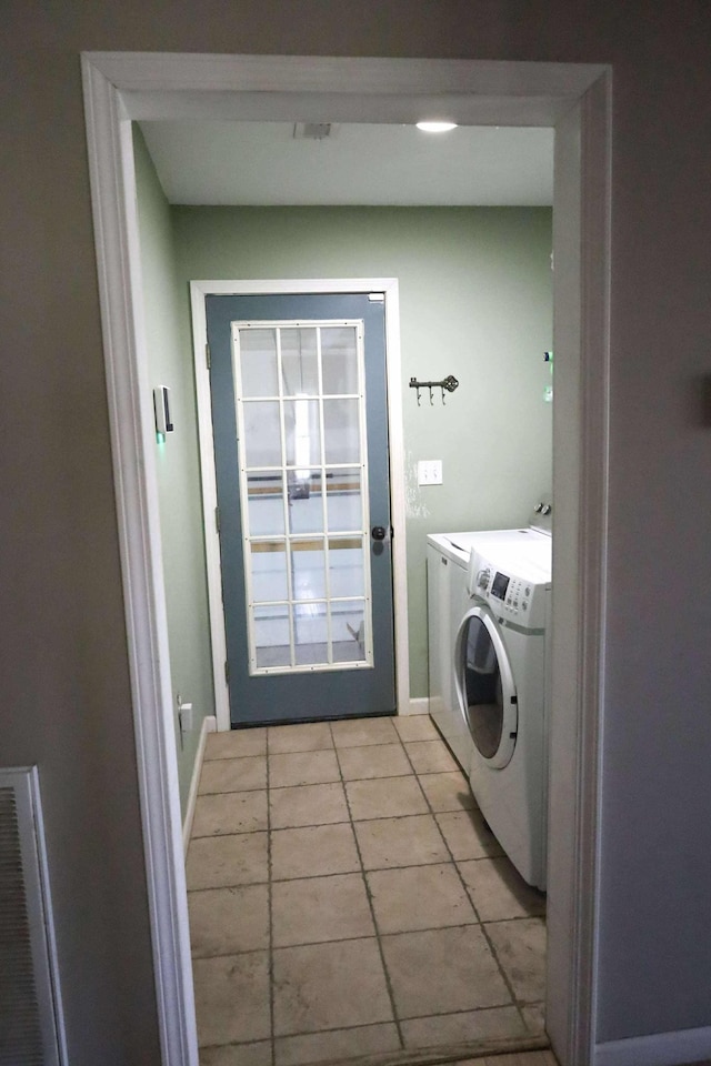1335 Bumpus Mills Rd, Dover, TN 37058 - washroom featuring washing machine and clothes dryer, visible vents, baseboards, light tile patterned floors, and laundry area