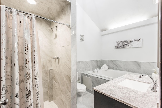 bathroom with toilet, vanity, vaulted ceiling, a shower stall, and a bath