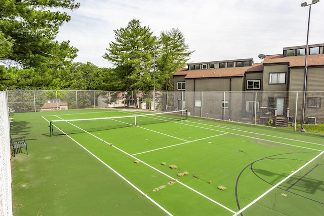 view of tennis court featuring fence