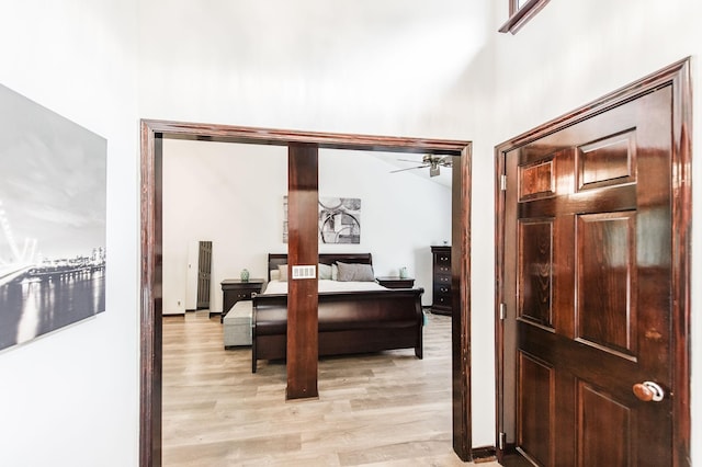 interior space with a towering ceiling and light wood finished floors