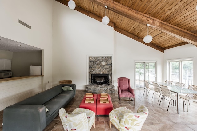 tiled living room featuring wood ceiling, high vaulted ceiling, a fireplace, and beam ceiling