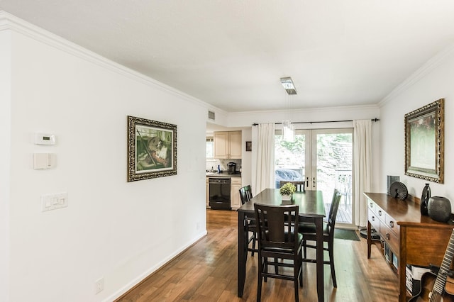 dining room featuring baseboards, visible vents, dark wood finished floors, ornamental molding, and french doors