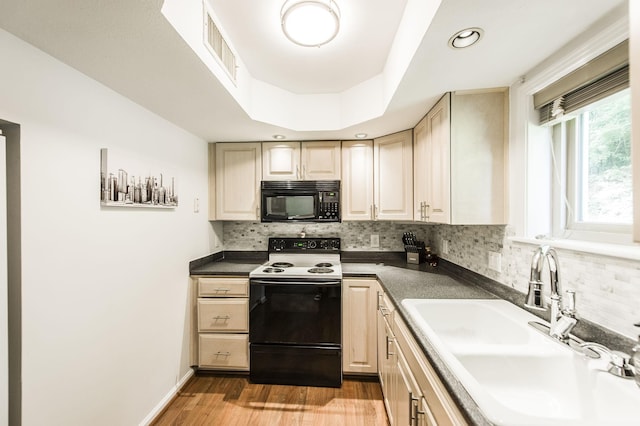 kitchen with electric stove, visible vents, backsplash, a sink, and black microwave