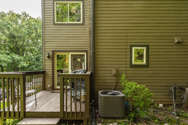 back of house featuring a deck and cooling unit