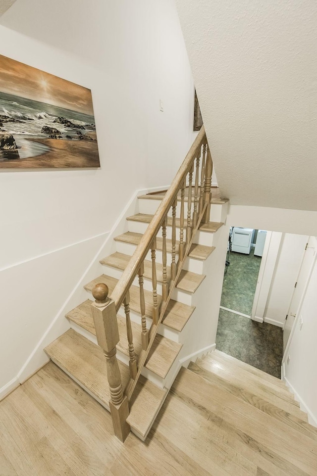 stairway featuring wood finished floors