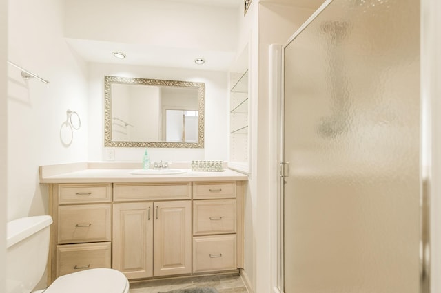 bathroom featuring visible vents, a shower stall, toilet, and vanity