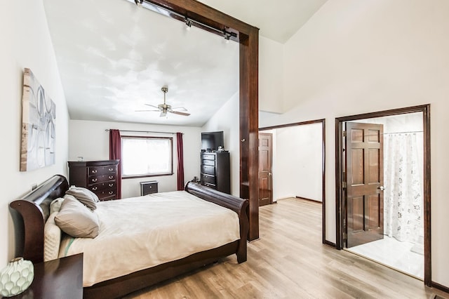 bedroom featuring vaulted ceiling, ceiling fan, and light wood-type flooring