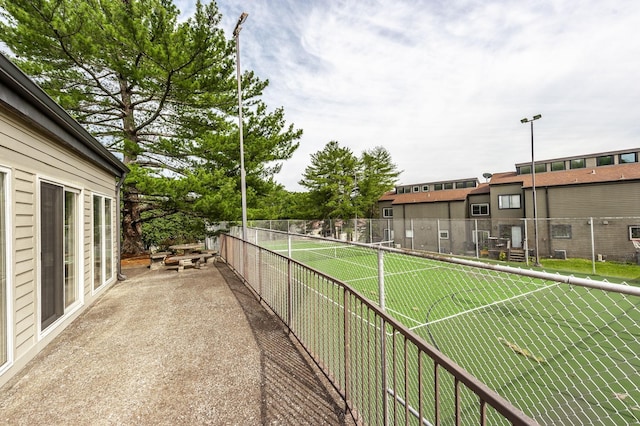 view of sport court with fence