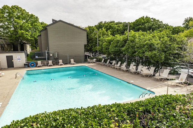 community pool featuring a patio and fence