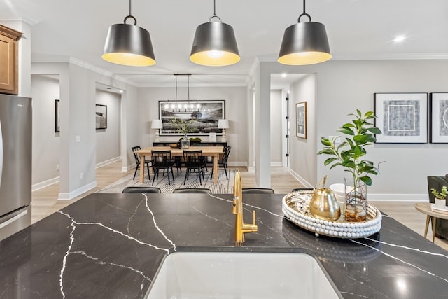 interior space with baseboards, light wood-style flooring, crown molding, ornate columns, and recessed lighting