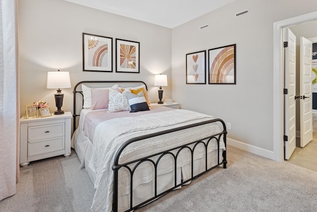 bedroom featuring light carpet, baseboards, and visible vents