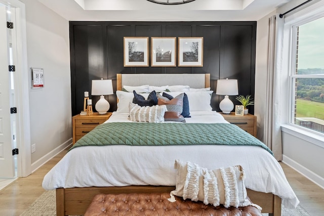 bedroom featuring light wood-style flooring and baseboards