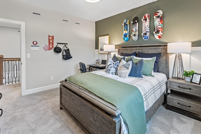 bedroom featuring light carpet, visible vents, and baseboards