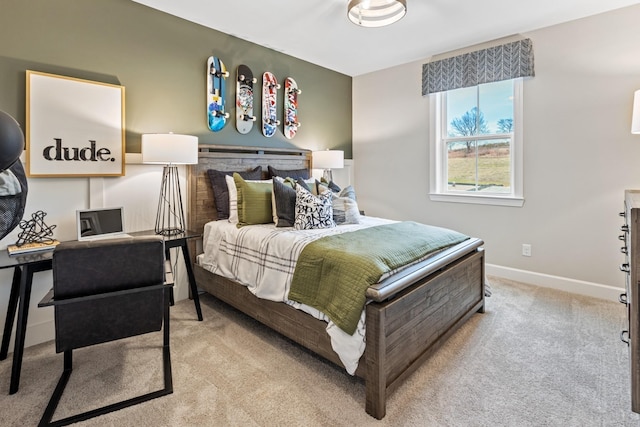 bedroom featuring light colored carpet and baseboards