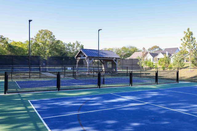 view of sport court featuring fence