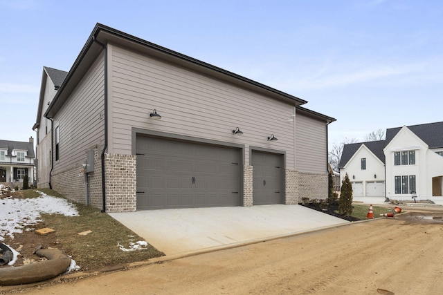 exterior space featuring brick siding and driveway