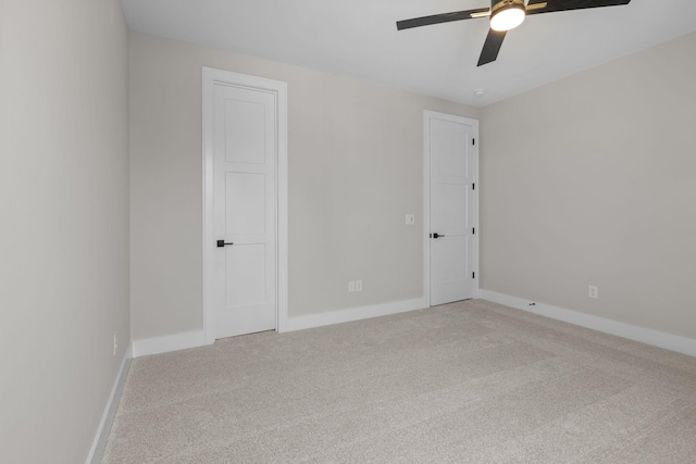 unfurnished room with light carpet, ceiling fan, and baseboards