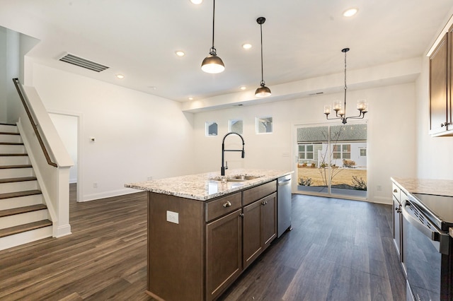 kitchen with dark wood finished floors, visible vents, stainless steel dishwasher, a sink, and range with electric cooktop