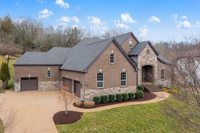 view of front facade featuring concrete driveway, brick siding, and a front lawn