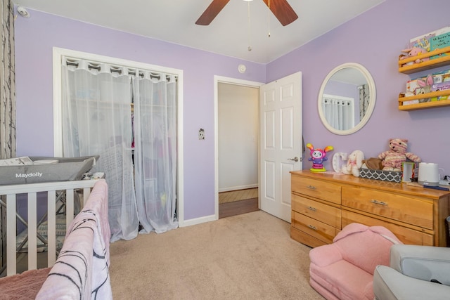 bedroom with baseboards, a ceiling fan, and light colored carpet