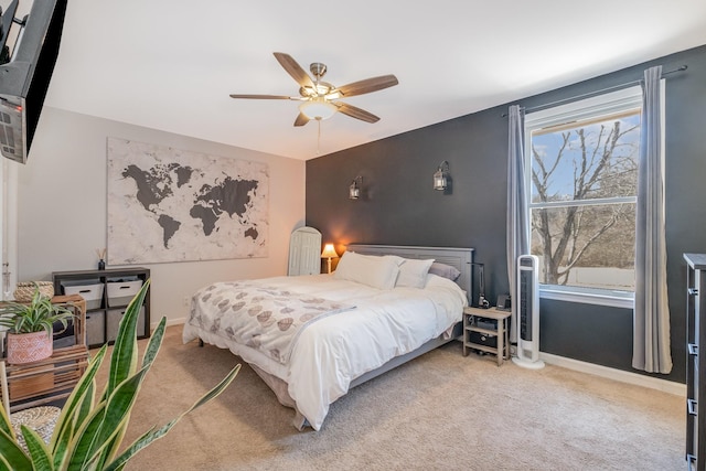 bedroom with ceiling fan, carpet flooring, and baseboards