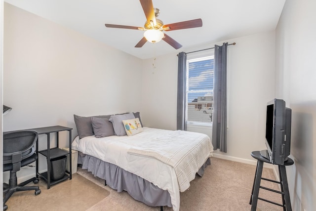 bedroom with light carpet, ceiling fan, and baseboards