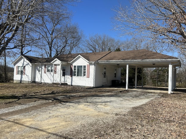 view of front of home with driveway and an attached carport