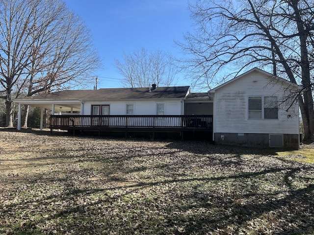 rear view of house with crawl space and a deck