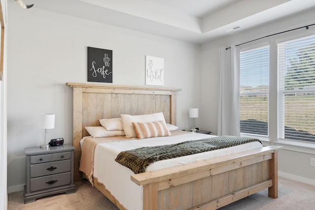 bedroom featuring visible vents, baseboards, and light colored carpet