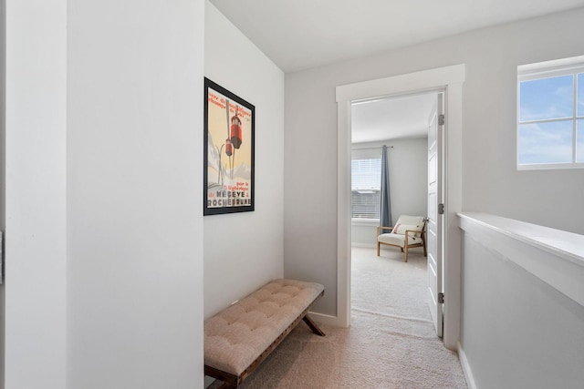 hall with carpet flooring and baseboards